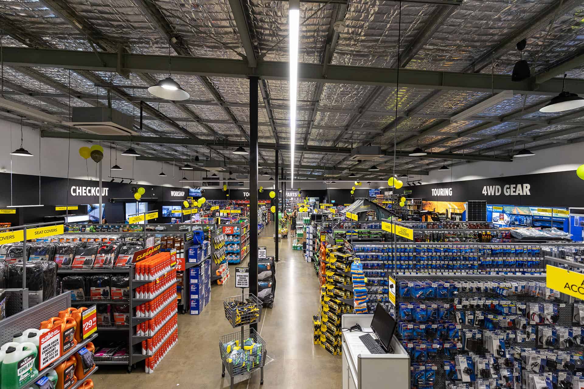 Commercial retail fitout completed by Airey Building Group at Autobarn Upper Coomera, featuring modern retail shelving, LED lighting, automotive product displays, 4WD accessories and a professionally designed showroom layout.